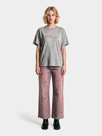 Pink low-rise jeans with metal eyelets by Colmillo de Morsa, front view