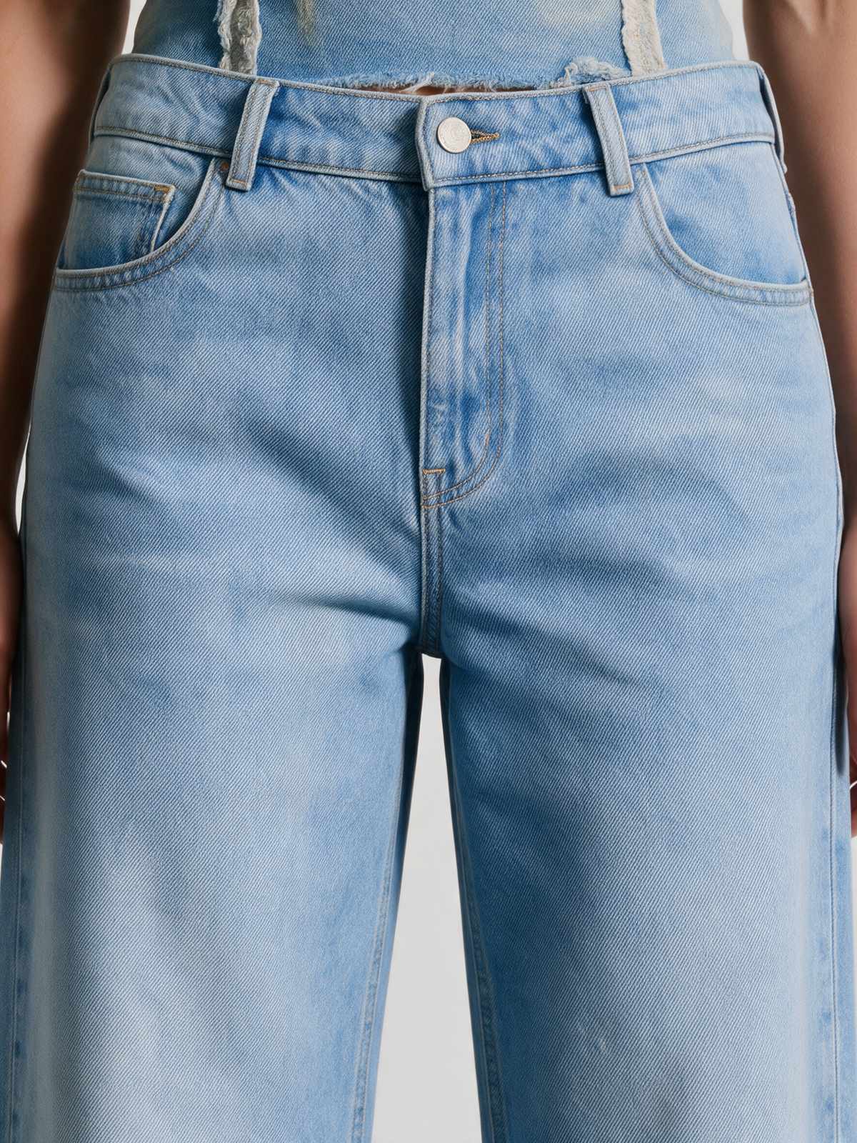 Blue denim jeans, close-up of the waist and pockets