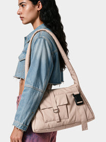 Beige padded cargo shoulder bag worn on the shoulder
